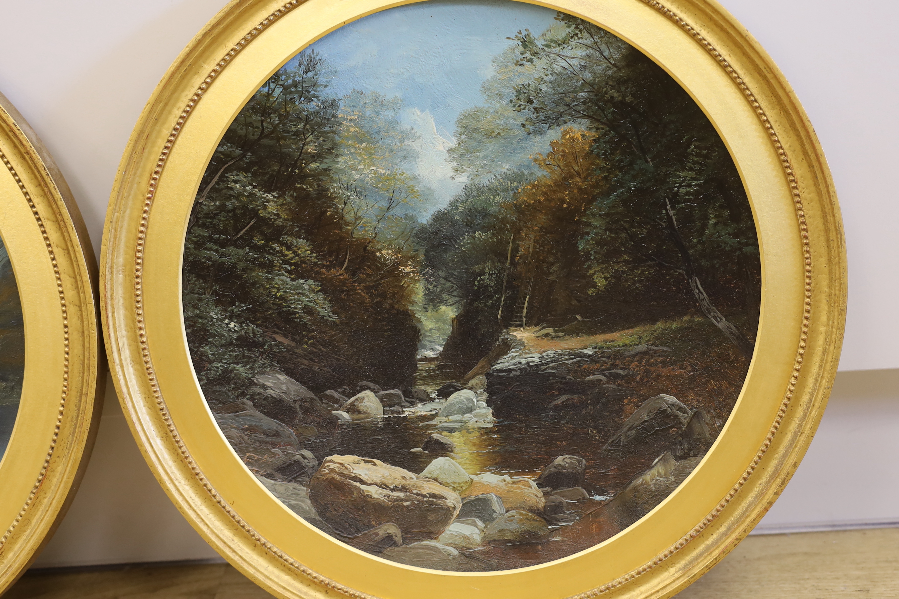 Late 19th / early 20th century, pair of oils on concave tin panels, Rocky river landscapes, each 39cm diameter